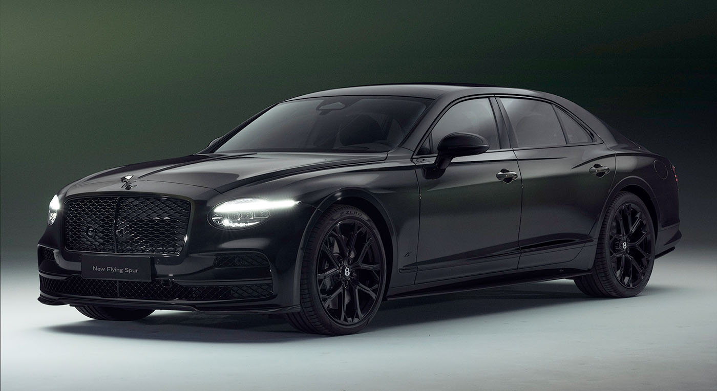 Sleek black luxury Bentley Spur sedan with tinted windows and illuminated headlights, set against a dark gradient background. The car exudes elegance and power.